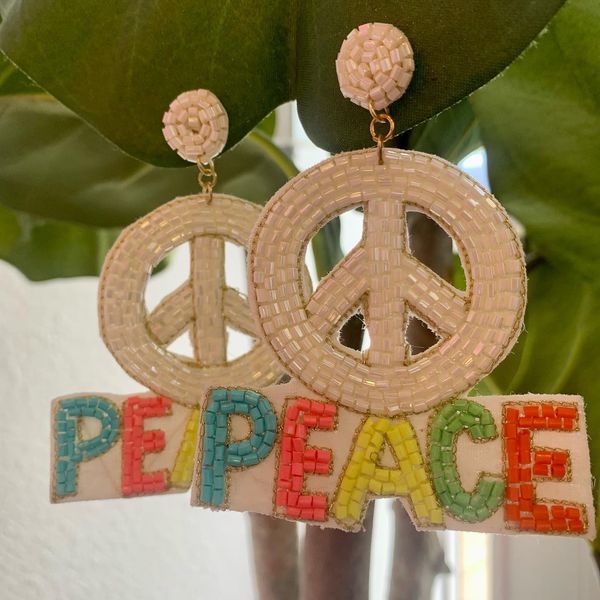Beaded white peace sign earrings